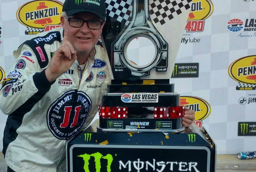 Mike McCarville poses with the championship trophy from the Pennzoil 400 in Las Vegas on March 4.