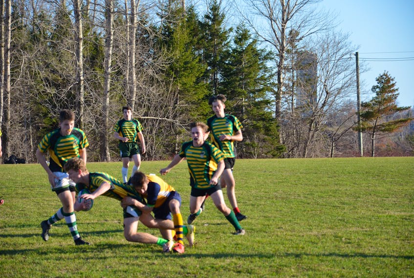 Cole Gallant of the visiting Westisle Wolverines tackles Ben Thompson of the Three Oaks Axemen during a P.E.I. School Athletic Association Senior AAA Boys Rugby League game in Summerside recently. Other Axemen hustling to get involved in the play are Dexter Stewart, left, Brandon Arsenault, front right, Caleb Dawson, back left, and Brandon Gillis.