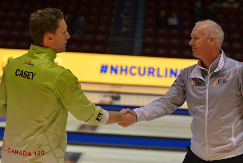 Skips Adam Casey, left, and Glenn Howard shake hands after a round-robin game in the 2017 Home Hardware Road to the Roar Pre-Trials curling event at Eastlink Arena on Friday morning. Howard won the game 7-6.