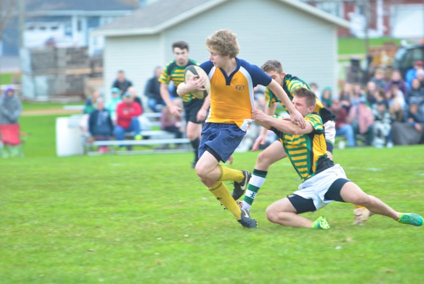 Aydan Kinch of the Westisle Wolverines attempts to break a tackle attempt by the Three Oaks Axemen’s Cole Gallant during second-half action Thursday evening. The host Axemen defeated the Wolverines 24-5 in the opening game of the 22nd annual David Voye Memorial rugby tournament in Summerside.