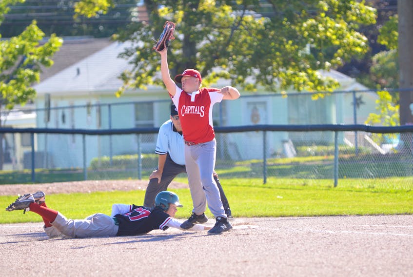 Josh Burgess of the Summerside Chevys slides safely back into first base on this pick-off attempt during Friday’s round-robin game against the St. John’s Capitals from Newfoundland and Labrador at the Baseball Canada 2018 Atlantic 13-and-under championship at Queen Elizabeth Park in Summerside. Capitals first baseman Hudson White fields the high throw. Summerside went on to win the game 8-4.