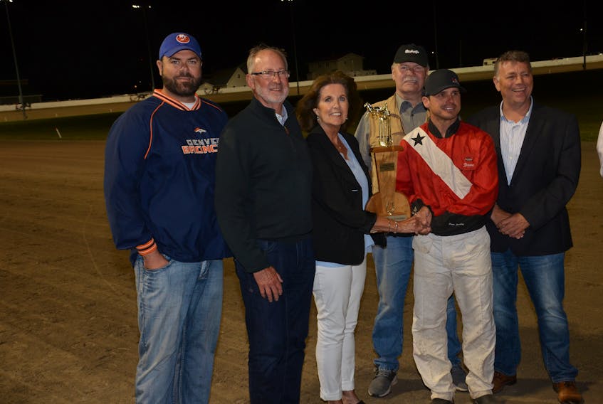 Patsy Noonan, daughter of Basil Whelan, presents the Basil Whelan Memorial Award to David Dowling. The award is presented to the top driver for Governor’s Plate Week harness racing at Red Shores at Summerside Raceway. Also taking part in the presentation were, from left: Colin Bassett, grandson of Basil Whelan, son-in-law Ivan Noonan, son-in-law Barry Bassett and P.E.I. Premier and family friend Dennis King. Dowling completed the six-race meet with 13 wins.