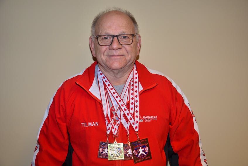 Tilman Gallant of Summerside proudly wears the four medals – one gold and three bronze – he won at the International Powerlifting Federation’s Classic world powerlifting championships in Calgary recently. Gallant also set a world record in bench press for the Master 4, 93-kilo category.