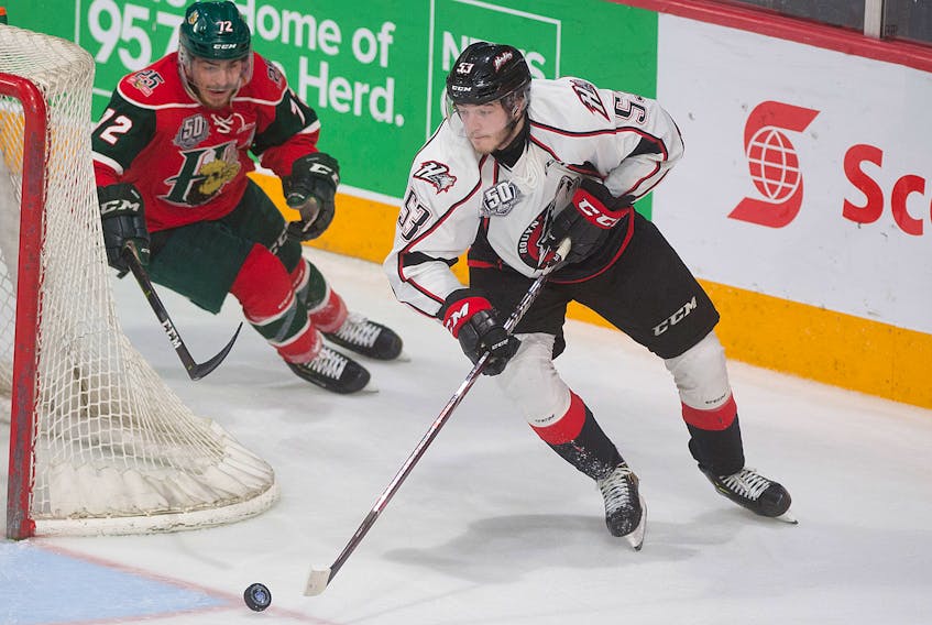 Rouyn-Noranda Huskies defenceman Noah Dobson carries the puck while being chased by the Halifax Mooseheads’ Samuel Asselin during Game 6 of the Quebec Major Junior Hockey League championship series at Scotiabank Centre in Halifax, N.S., on May 11.