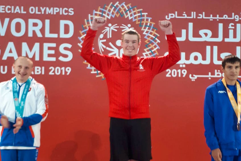 Roy Paynter, centre, stands on the gold-medal podium at the 2019 2019 Special Olympics World Summer Games in Abu Dhabi on Sunday. Paynter, the lone Special Olympics P.E.I. athlete with Team Canada, won gold in the 200-metre freestyle.