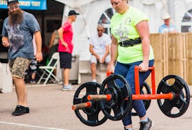 Shelley Ford-Lilly of Summerside competes in the farmer’s walk event of the P.E.I. strong woman competition held on the grounds of Credit Union Place on Saturday afternoon as part of the Lobster Carnival. Katrina Kuzminer-Arsenault Photo