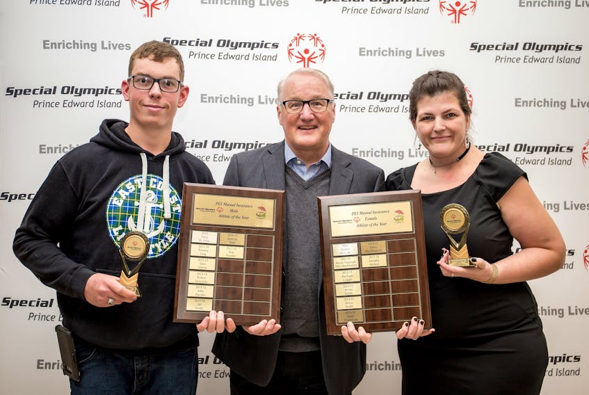 oy Paynter of Kensington and Jennifer Hickox of Charlottetown accept the Special Olympics P.E.I. athletes of the year awards from Blair Campbell, CEO of award sponsor P.E.I. Mutual Insurance Company.