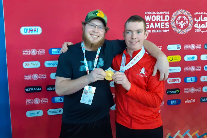 Roy Paynter, right, receives congratulations from his brother, Gary, after winning his second gold and third medal overall at the 2019 Special Olympics World Summer Games in Abu Dhabi on Wednesday. Paynter’s latest gold came in the 100-metre breaststroke. His time was 1:44.76.