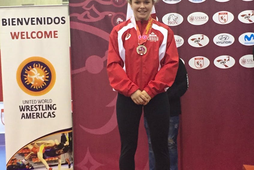 Hannah Taylor poses with the silver medal she won at the Junior Pan Am championships in Lima, Peru, in June.