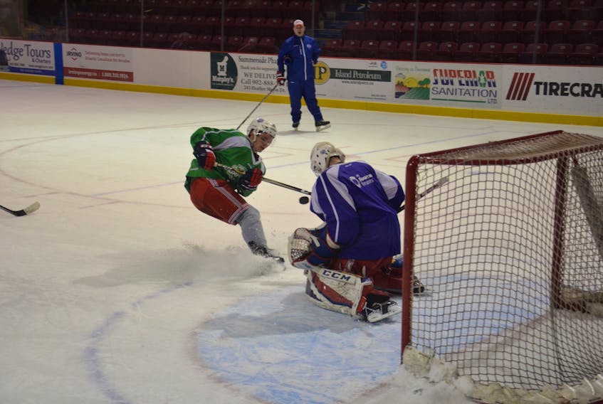 Summerside D. Alex MacDonald Ford Western Capitals’ rookie forward Cameron Roberts gets a shot off on goaltender Dominik Tmej while head coach Billy McGuigan looks on during Tuesday afternoon’s practice at Eastlink Arena.