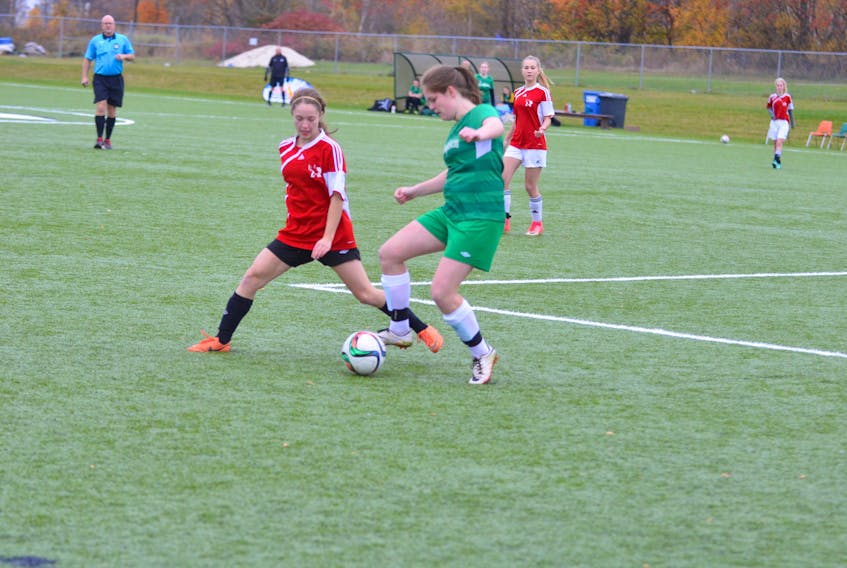 Ellen Cole, right, of KISHORA and the Charlottetown Rural Raiders’ Riley Chappell battle for control of the ball in overtime of the P.E.I. School Athletic Association Senior A Girls Soccer League championship game at UPEI on Saturday morning. The Raiders won the contest in penalty kicks. Jason Simmonds/Journal Pioneer