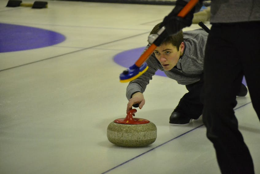 Leslie Noye, second stone on the Alex MacFadyen rink from the Silver Fox in Summerside, keeps his eyes on the target broom as he releases a stone during P.E.I. Pepsi junior men’s curling championship at the Maple Leaf Curling Club in O’Leary.