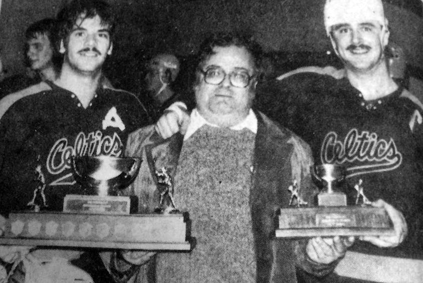 Don Johnson presented the first-ever Don Johnson Cup, donated by the Community Gardens in Kensington, to the captains of the St. John’s Celtics – son Mike Johnson, left, and Dave Goodland. The Celtics defeated the Kensington Bombers 5-3 in championship game of the inaugural Atlantic junior B hockey championship tournament played in Kensington on April 26, 1982.