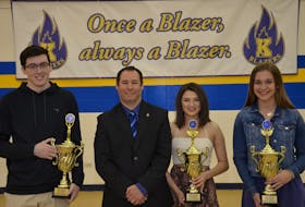 Kinkora Regional High School athletic director Trent Ranahan, second left, congratulates the 2017-18 athletes of the year. Robert Greenan was named the male recipient while Callie Thomson, second right, and Madeline Hamill were announced as co-winners of the female award.