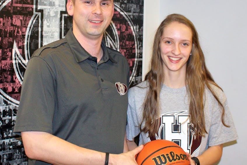 Holland Hurricanes head coach Jared Cheverie chats with Ashley Plaggenhoef, who will join the Atlantic Collegiate Athletic Association women’s basketball team for the 2018-19 season.