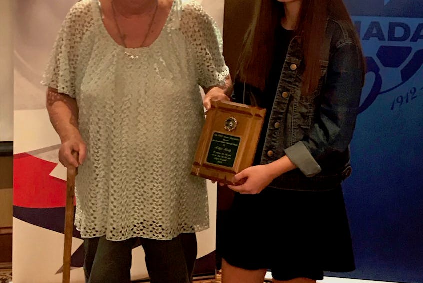 Ardyn Hardy recently accepted the Lowell Stewart Memorial Award from Marg Stewart at the recent P.E.I. Soccer Association annual awards.