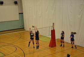 The Kensington Torchettes’ Keanna Reid, left, attempts to hit the ball past the block attempt by Cassandra MacLeod during a team practice on Tuesday afternoon in preparation for this weekend’s 44th annual Kensington Intermediate-Senior High School Volleyball Extravaganza.