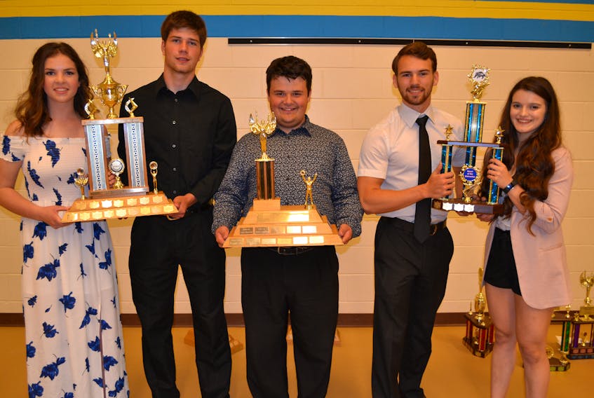 Displaying some of the major hardware presented at the Westisle Sports Awards Dinner are, from left: Gemma Shea and Sterling MacKendrick, sportsmanship; Tanner MacCollum, contribution to school athletics, and Chandler Gard and Joselyn Jelley, Heart of the Wolverine.