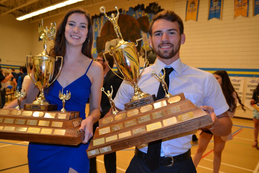 Lyndsay Callaghan and Chandler Gard, proudly display the Athlete of the Year awards they received during the Westisle Composite High School Sports awards dinner.