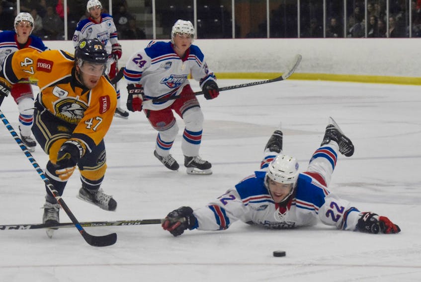 Summerside Western Capitals defenceman Noah Massie dives in an attempt to knock the puck away from the Yarmouth Mariners’ Logan Timmons. The Mariners won the MHL (Maritime Junior Hockey League) game 5-1 at the Mariner Centre on Saturday night.