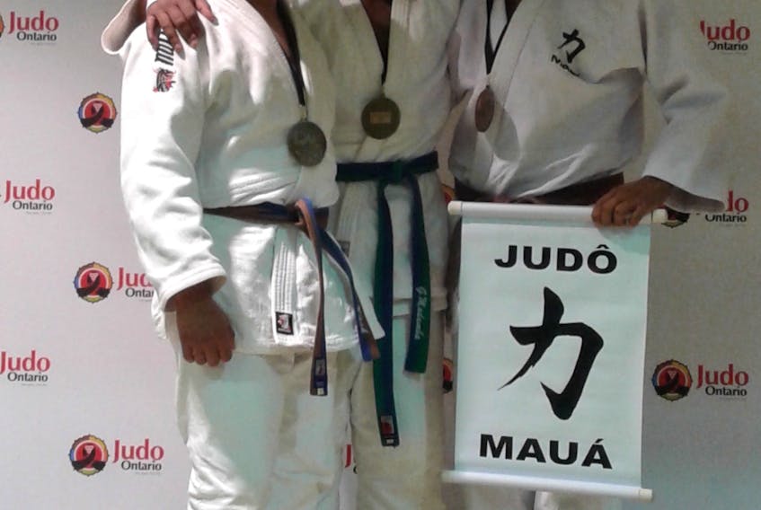 George Madumba, centre, won gold in under-18 male -90 kilograms at the recent Ontario Open international judo event in Toronto. Sebastian Nash, left, of Middleton claimed silver while Erik Lima Silva of Brazil captured the bronze medal.