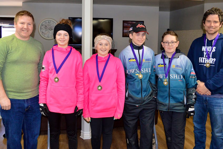 The Brayden Snow rink from the Silver Fox in Summerside won the A Division at the P.E.I. under-13 curling championships in Alberton recently. Members of the winning rink receive congratulations from Curl P.E.I. representative Dennis Watts, left. From left: Makiya Noonan, lead; Mallory Rochford, second stone, Anderson MacDougall, third stone; Snow, and Andrew MacDougall, coach.
