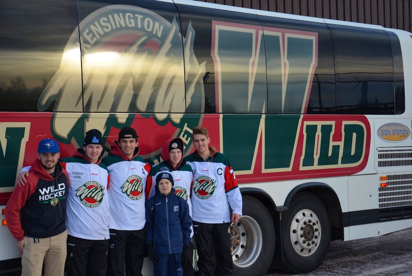 Cameron Hunter chats with Kensington Monaghan Farms Wild players, from right, captain Clark Webster, Landon Clow, Evan Gallant, Zac Arsenault and team official A.J. Cahill before boarding the team bus for Friday night’s game in Moncton, N.B.
