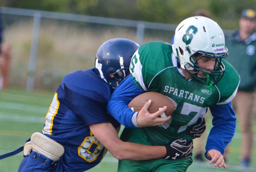 The Cornwall Timberwolves’ Ben Zhou tackles the Summerside Waterwise Spartans’ Paul Wamboldt during a Papa John’s P.E.I. Bantam Tackle Football League regular-season game at Eric Johnston Field on Sept. 29. The two teams will meet in the Ed Hilton Bowl in Summerside on Saturday at noon.
