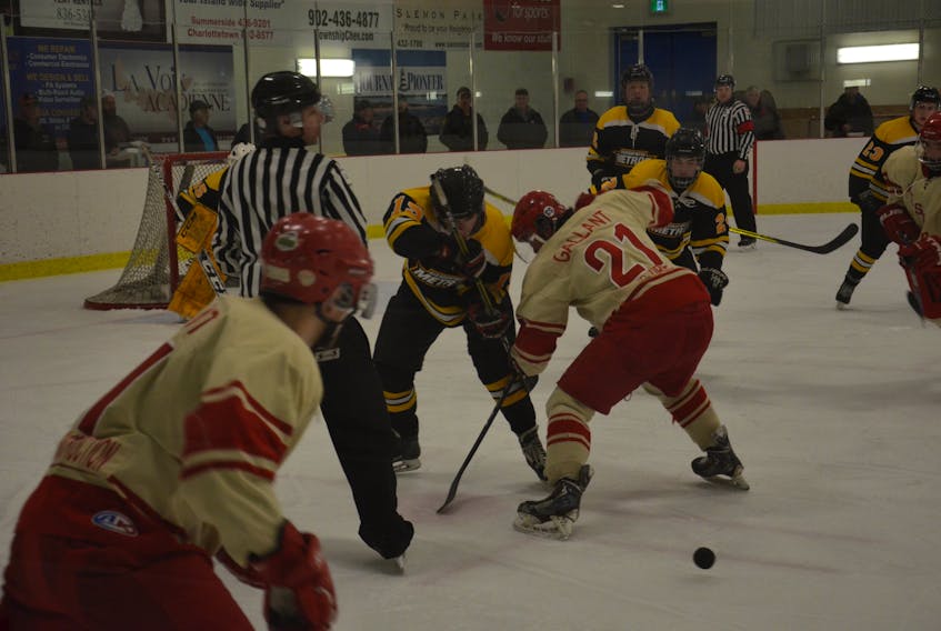 Western Red Wings captain Chasse Gallant and the Sherwood-Parkdale Metros’ Barrington Duffy battle for possession of the puck off a faceoff during Game 3 of the Island Junior Hockey League championship series at the Evangeline Recreation Centre in April.