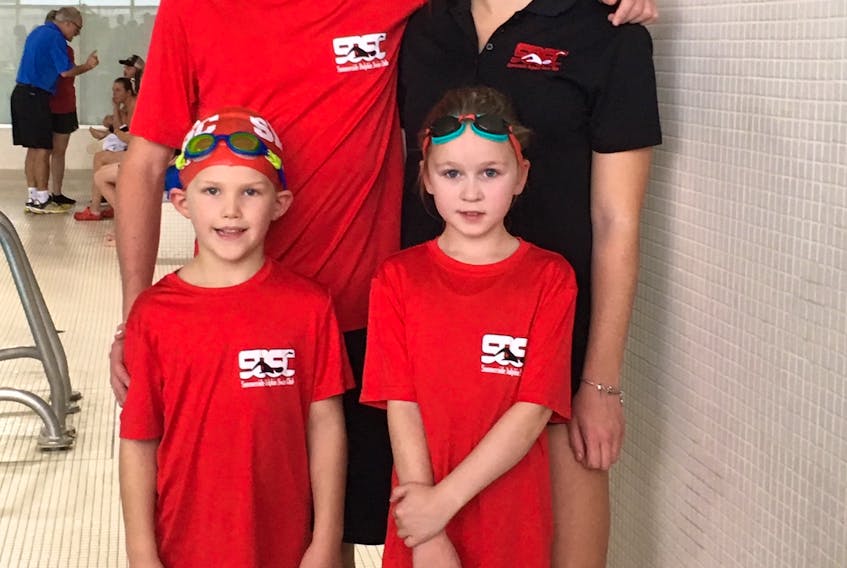 Grade 12 senior swimmers Logan Palmer and Abbey Corish pose with fellow Summerside Dolphins Milo Cameron and Mila Cameron, who were competing in their first competitive meet on Saturday. The First Chance Fall Swim Meet was held at Credit Union Place.