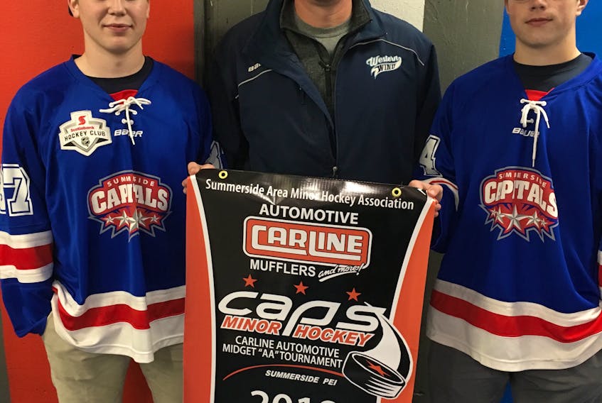 Paul Campbell, representing tournament title sponsor Carline Automotive discusses this weekend’s midget AA pre-season hockey tournament at Credit Union Place in Summerside with the two members of the host Summerside Capitals, Blake Vandervelden, left, and Dexter Stewart.
