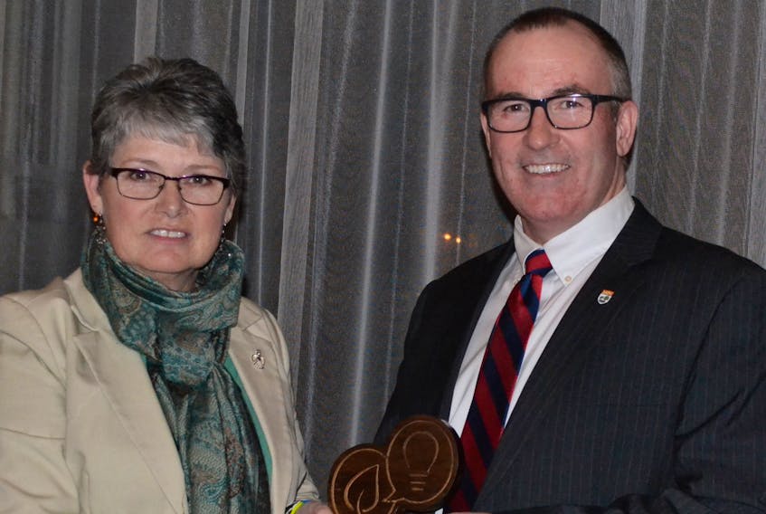 Economic Development and Tourism Minister Chris Palmer presents Janet Ogilvie, owner of Green Gable Alpacas, with the Innovation P.E.I Best Website, Best Social Marketing Award during the West Prince Chamber of Commerce's inaugural Business Excellence Awards Gala held recently.