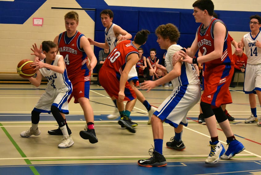 The Summerside Intermediate School Owls’ Will Somers searches for an opening to pass the ball while being defended by Tyler Newson of the East Wiltshire Warriors. The action took place during a semifinal game in the P.E.I. School Athletic Association intermediate AA basketball championships at Summerside Intermediate School on Saturday afternoon. The final score was 65-38 in favour of East Wiltshire.