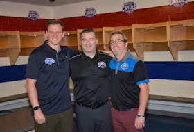 Summerside Western Capitals head coach Billy McGuigan, centre, and assistant coach Jason (Lefty) Gallant, right, welcome new assistant coach Jason Gallant to the MHL (Maritime Junior Hockey League team.