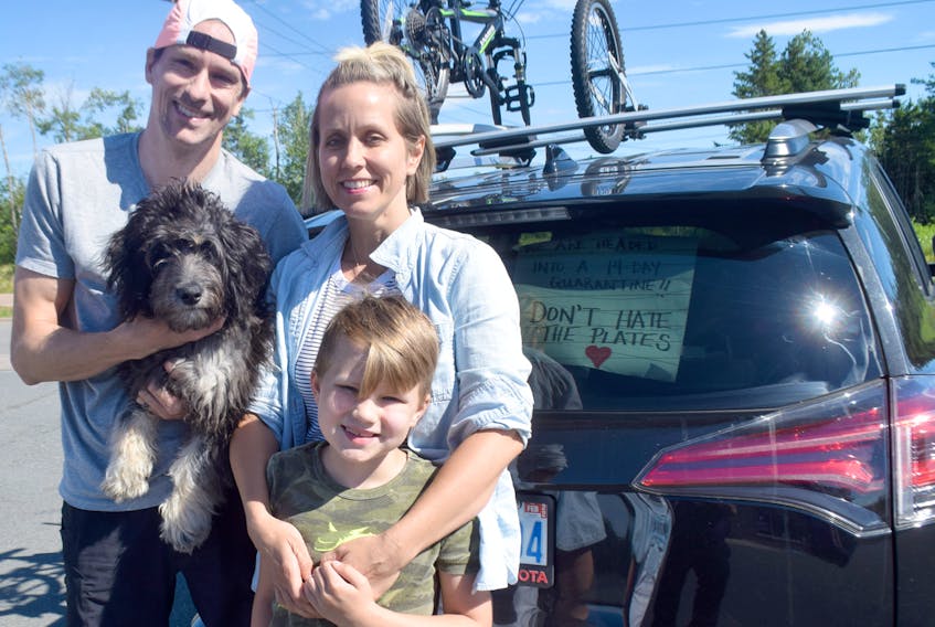 Don O’Neil, Cheryl Munroe, their son Will and dog Tesla came from Ontario this week to visit family and friends in Nova Scotia. Before leaving their home in Toronto, Cheryl made signs for their vehicle’s windows to let others know they have followed proper health protocols when it comes to COVID-19.