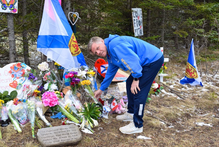 Jordan Henby of Bridgewater was one of numerous people who drove to Portapique on Thursday to lay flowers at the end of Portapique Beach Road in as a way to pay his respects to the victim's of this week's mass killings throughout the area.