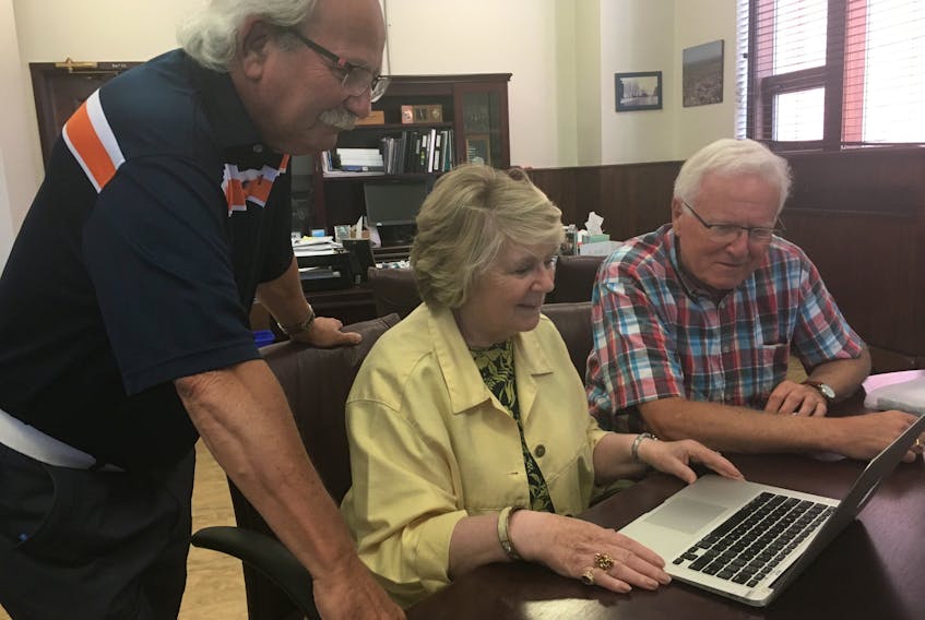 Amherst Mayor David Kogon, Amherst internment camp commemoration co-ordinator Marjorie MacLean and Cumberland-Colchester MP Bill Casey watch a video produced chronicling the First World War camp and the July 2 ceremony commemorating its 1919 closure.