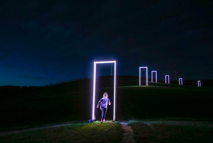 September 26, 2019 - A youngster enters one of 17 luminescent domestic doorways that make up the spatial installation, The Deep Dark, on Citadel Hill in Halifax. The piece was made by Calgary artists, Caitlind Brown and Wayne Garrett and is part of the Responsive International Light Art Project.