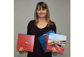 Velma LeBlanc, client information officer at the Wellington Rural Action Centre (RDÉE Prince Edward Island), shows the new kit that will be used to attract new Francophone immigrant workers and entrepreneurs to the Island.
