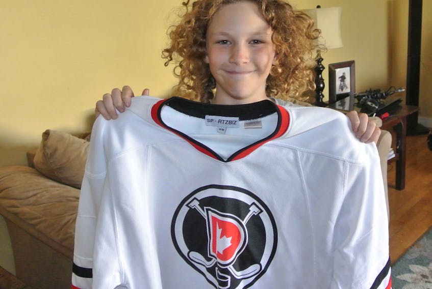Mackenzie Paris, who played peewee in the Cumberland County Minor Hockey Association this past season, holds up his Dskate hockey sweater in preparation for a hockey camp he’s heading to in Ottawa in August. The hockey school is like many others, but there’s an emphasis on diabetes education and balancing Type 1 diabetes and hockey.
