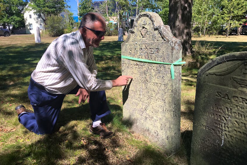 Robert Yorke looks over a headstone in the old Saint George’s Anglican Church Cemetery on Victoria Street in Parrsboro. The cemetery, that was the church’s burying ground from 1792 until 1890, is being restored with the support of the parish and the W.B. Wells Heritage Foundation.