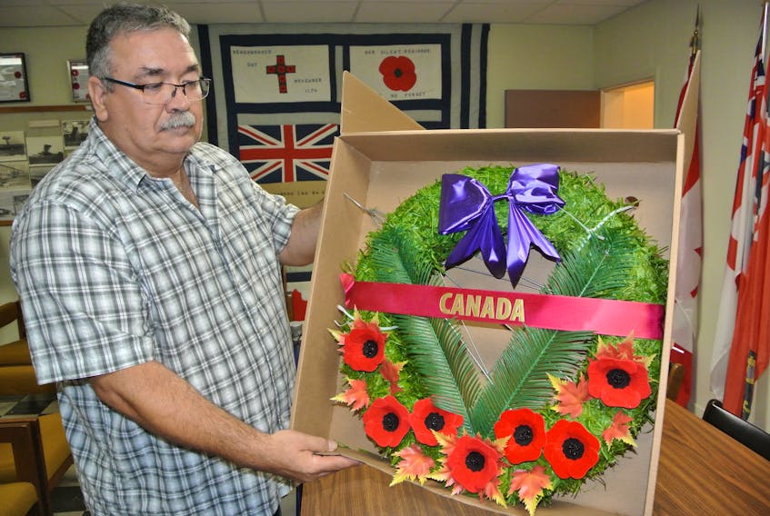 Royal Canadian Legion Branch 45 sergeant at arms Don Forbes looks over one of the wreaths that will be laid during the Remembrance Day ceremony in Parrsboro on Nov.11. This year, only eight official wreaths will be laid at the cenotaph during the official ceremony. Families are invited to lay their wreaths following the official ceremony.