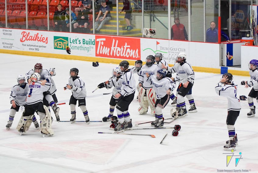 Members of the Cumberland County Peewee AA Ramblers pour off the bench to celebrate their overtime win during the Day of Champions at the Rath Eastlink Community Centre in Truro on Saturday. The Ramblers defeated Halifax 5-4 in overtime to win the Nova Scotia championship. - Team Impact Sports photo