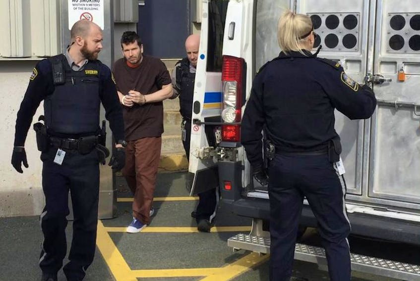 Peter Guy Joseph Monteith, shown being escorted out of the Dartmouth courthouse in November, is accused of robbing the same bank twice in less than a week.