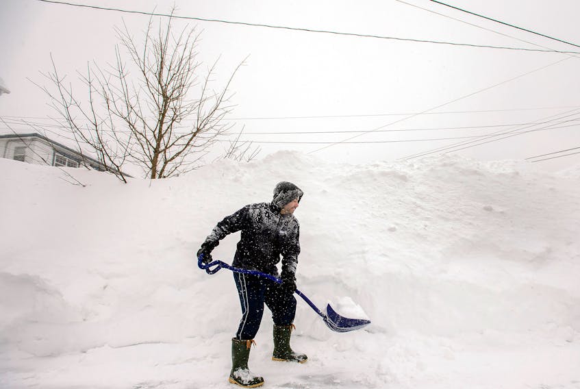 A Bedford NS man shovels his driveway March 18, 2015, following a St. Patrick's Day storm that dumped close to 60 cm of snow over many parts of Nova Scotia.