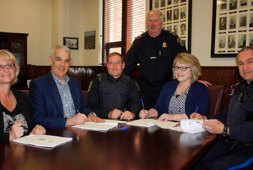 Representatives of Amherst and Local 104 of the Atlantic Police Association sign a new five-year contract. Among those taking part in the signing ceremony were: (from left) police department administrative assistant Jean Jacklin, Amherst CAO Greg Herrett, Const. Tom Wood, Chief Ian Naylor (standing), Deputy Mayor Sheila Christie and Staff Sgt. Scott White.