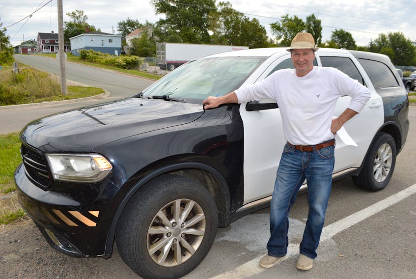 John LeMoine of New Waterford stands by his 2014 Dodge Durango, a former police vehicle he purchased through a CBRM tender last year. LeMoine said he wanted the vehicle because it was cheap and works great but also because it's a great conversation piece.