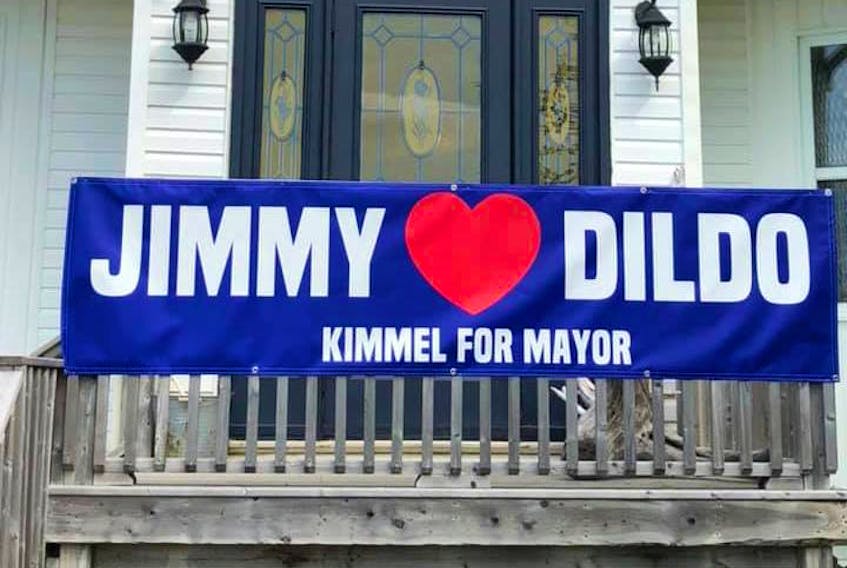 Campaign posters to have Jimmy Kimmel elected mayor are posted on various homes and businesses in Dildo — including this one at Dildo Cove Coffee and Krafts — in the hopes that the American late-night talk show host will visit the town.