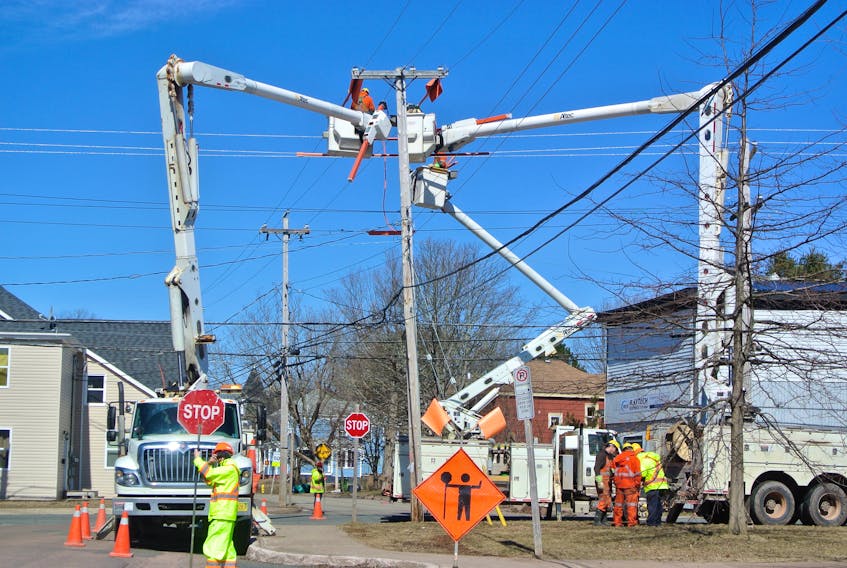 Crews from Nova Scotia Power work at the corner of Spring and Academy Street in Amherst.