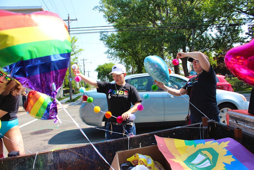 Nicole Chisholm, left and Violet Ross were busy decorating a Cape Breton Regional Municipality float prior to the start of the 19th annual Cape Breton Pride Parade. ERIN POTTIE/CAPE BRETON POST